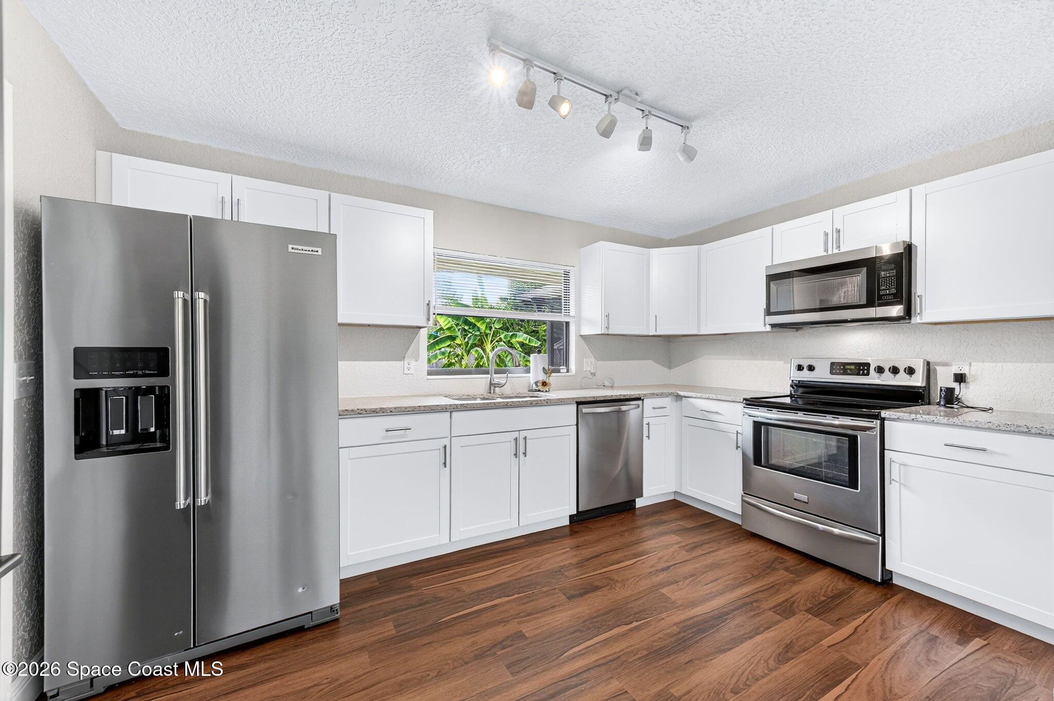 996 Botany Lane Rockledge, FL 32955 - Photo 14 of 35 a kitchen with stainless steel appliances a refrigerator sink and microwave
