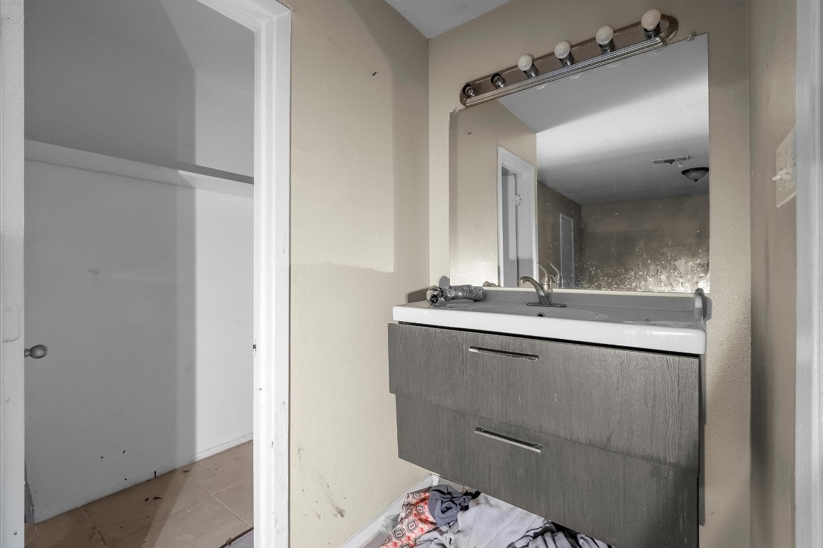 14504 Corpus Christi Street, Unit 4 Houston, TX 77015 - Photo 16 of 33 a bathroom with a granite countertop sink and a mirror