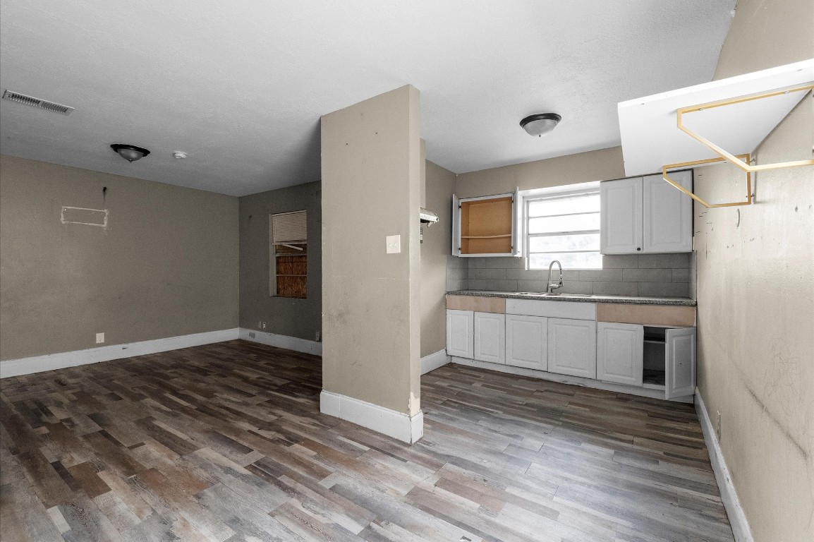 14504 Corpus Christi Street, Unit 4 Houston, TX 77015 - Photo 29 of 33 a kitchen with granite countertop white cabinets and white appliances
