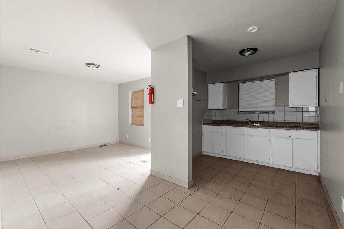 14504 Corpus Christi Street, Unit 4 Houston, TX 77015 - Photo 6 of 33 a kitchen with a refrigerator and white cabinets