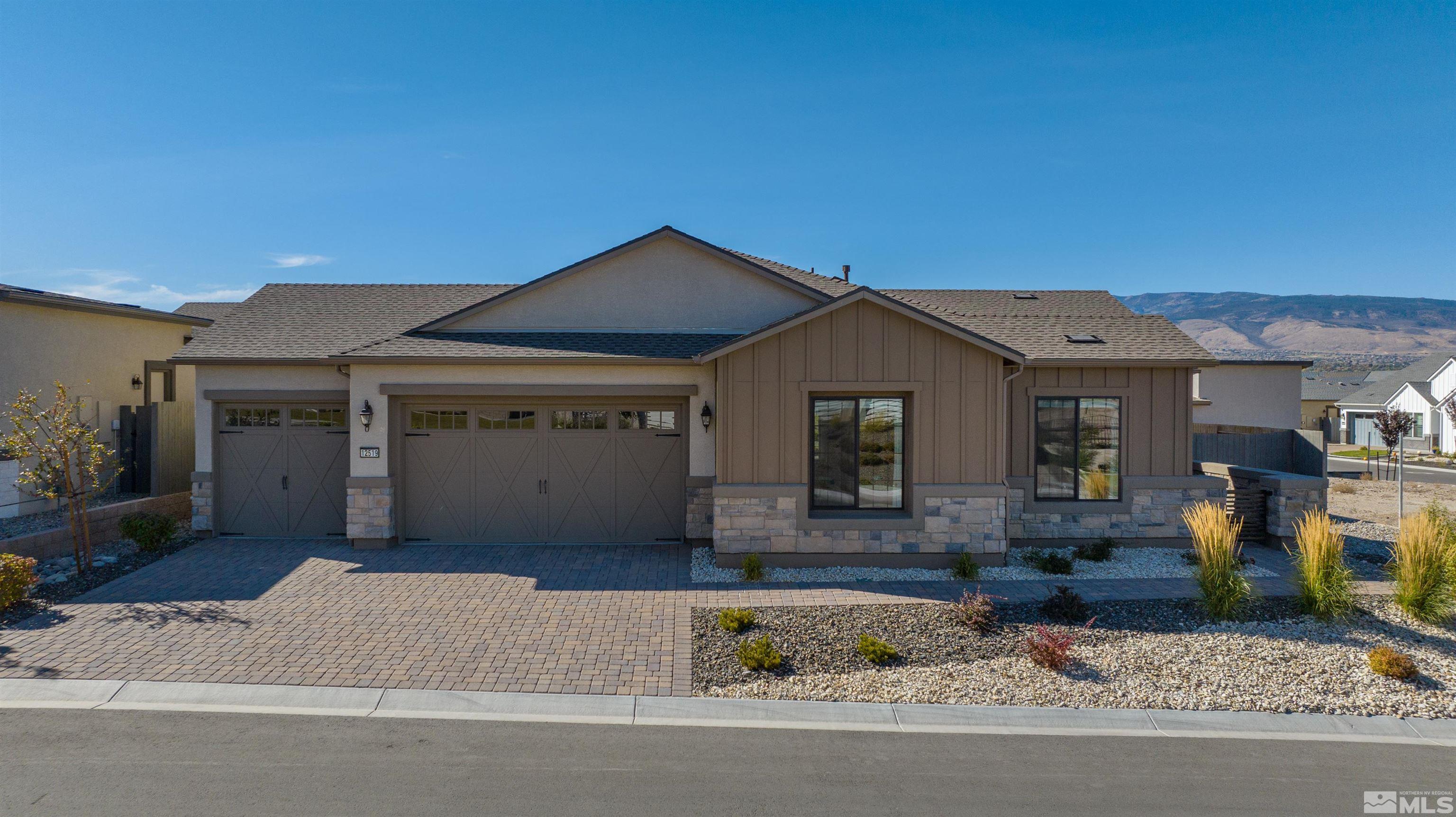 12519 Blue Stream Street, Unit HOMESITE 138 Reno, NV 89521 - Photo 1 of 9 a front view of a house with garage and balcony