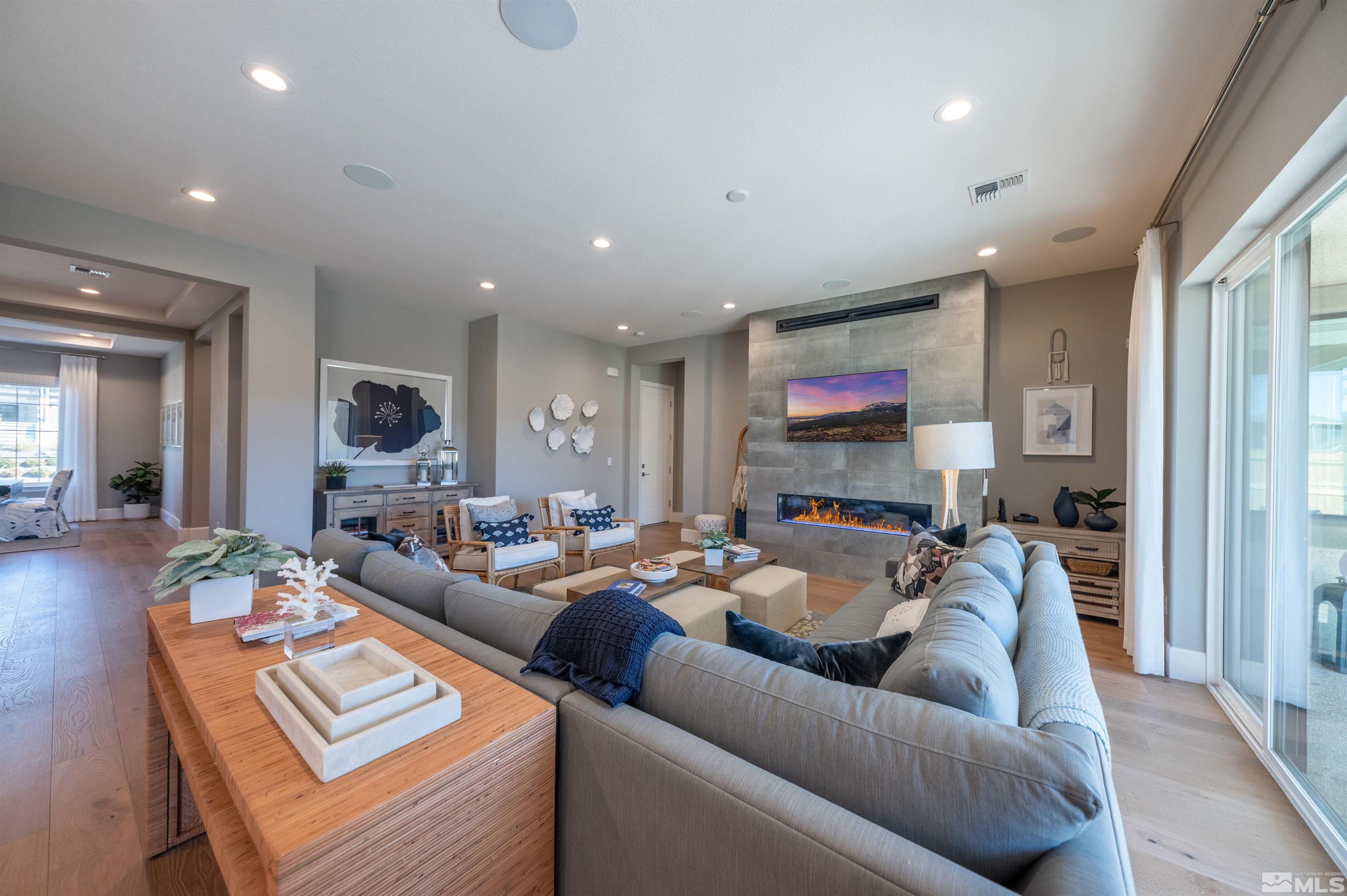 12519 Blue Stream Street, Unit HOMESITE 138 Reno, NV 89521 - Photo 3 of 9 a living room with furniture and a flat screen tv