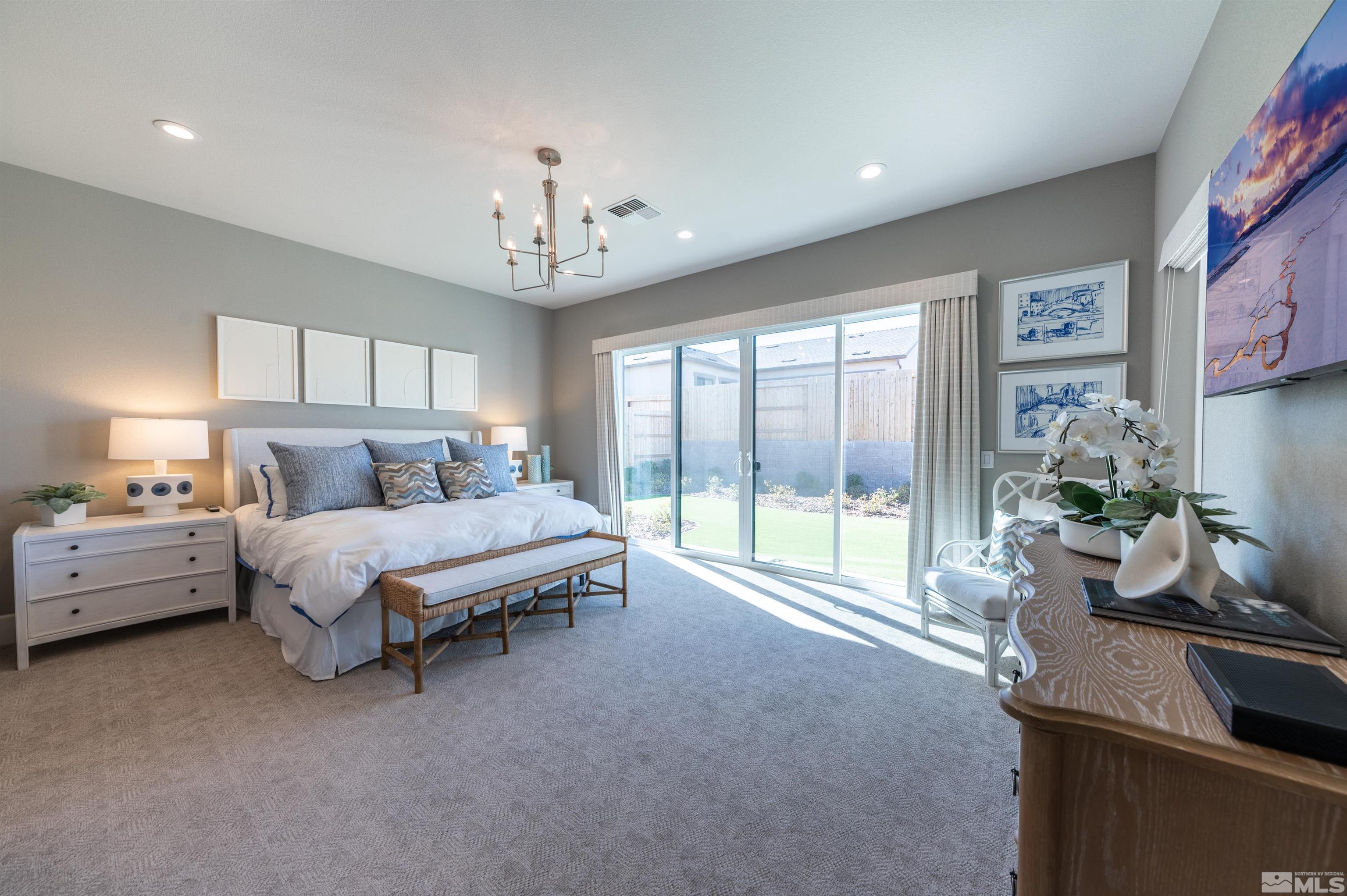 12519 Blue Stream Street, Unit HOMESITE 138 Reno, NV 89521 - Photo 6 of 9 a bed room with a bed and a chandelier