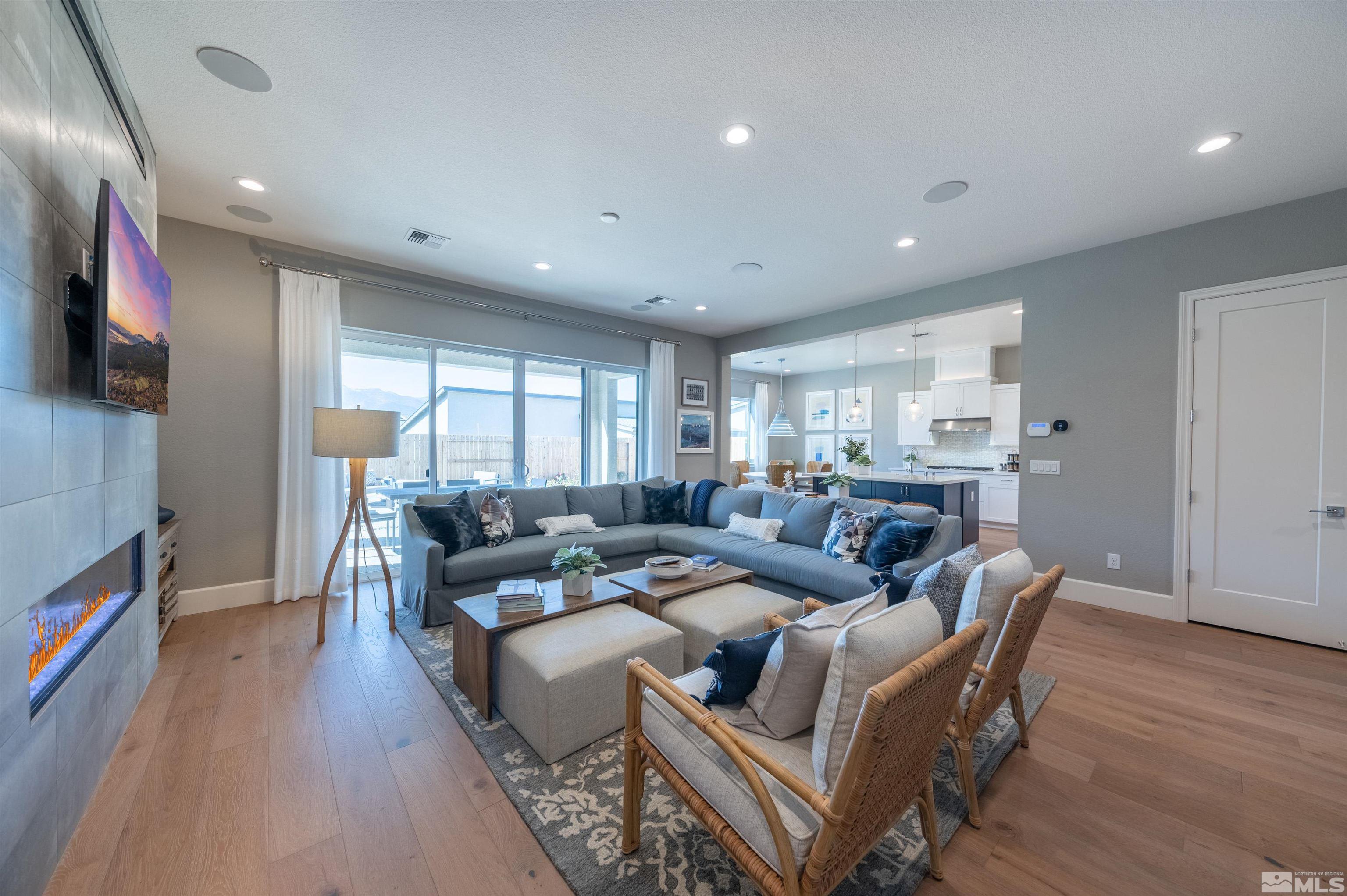12519 Blue Stream Street, Unit HOMESITE 138 Reno, NV 89521 - Photo 7 of 9 a living room with furniture and a flat screen tv