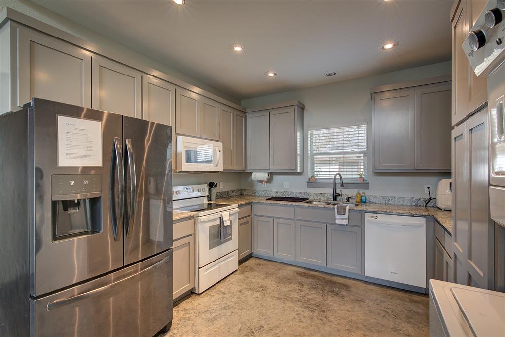 600 Maple Street Commerce, TX 75428 - Photo 11 of 35 a kitchen with stainless steel appliances a refrigerator sink and microwave