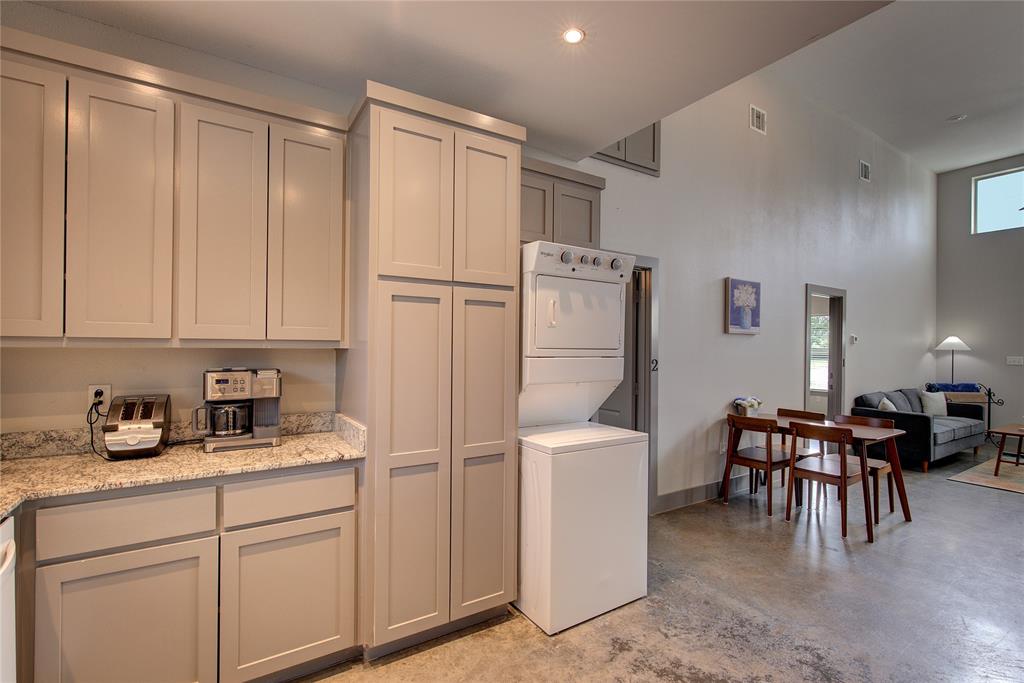600 Maple Street Commerce, TX 75428 - Photo 14 of 35 a kitchen with white cabinets and stainless steel appliances