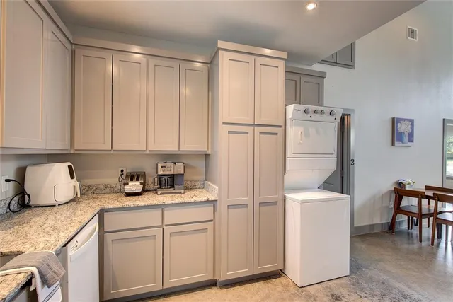 a kitchen with appliances cabinets and furniture