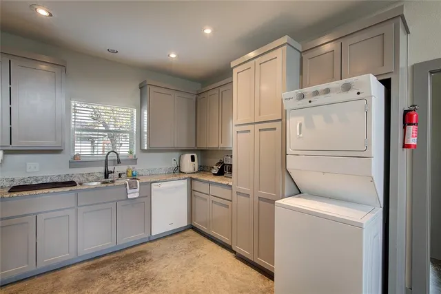 a kitchen with a refrigerator sink and cabinets