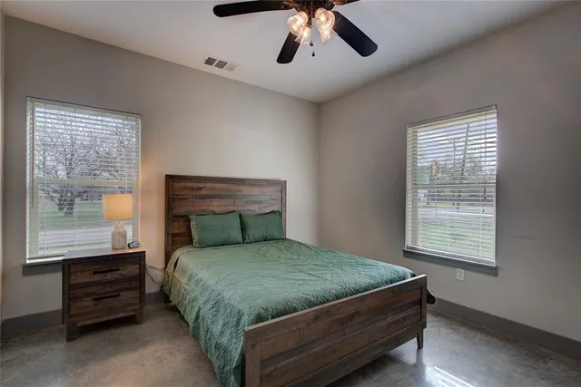 a bed sitting in a bedroom next to a window
