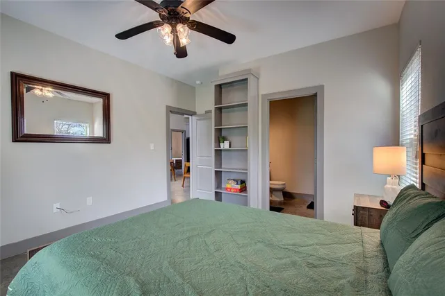 a bedroom with bed and a chandelier