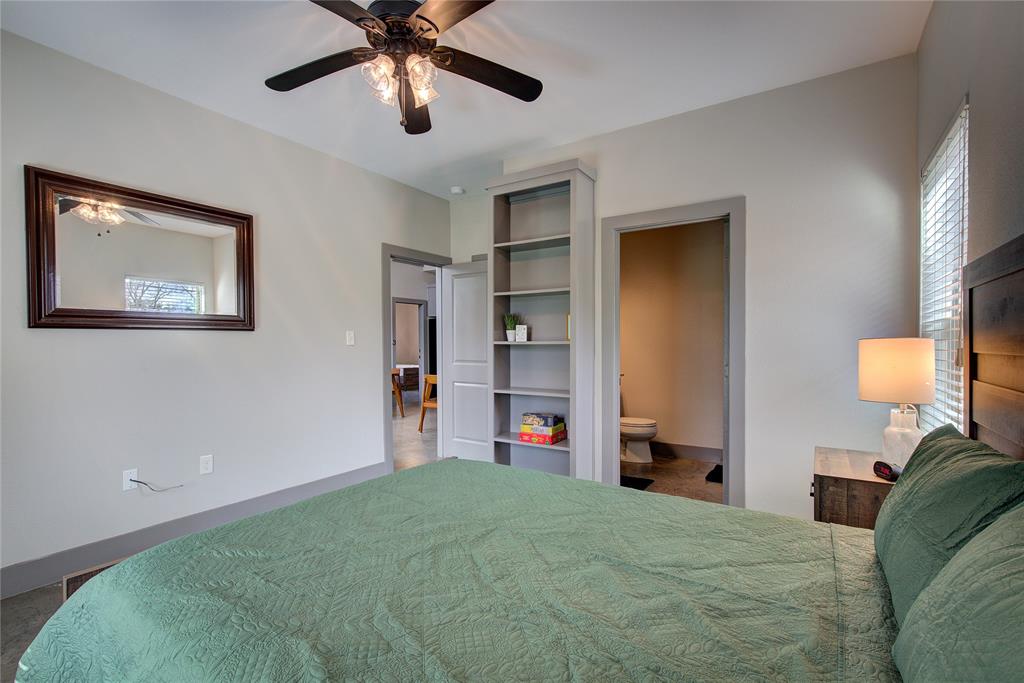 600 Maple Street Commerce, TX 75428 - Photo 19 of 35 a bedroom with bed and a chandelier