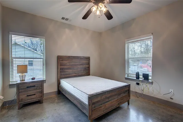 a bedroom with a bed and window