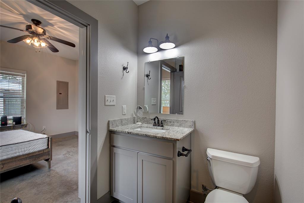 600 Maple Street Commerce, TX 75428 - Photo 26 of 35 a bathroom with a toilet sink and mirror