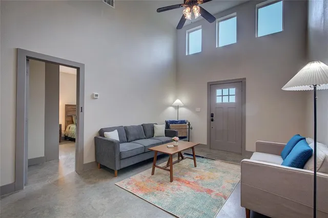 a living room with furniture and a lamp