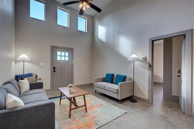 a living room with furniture and a lamp