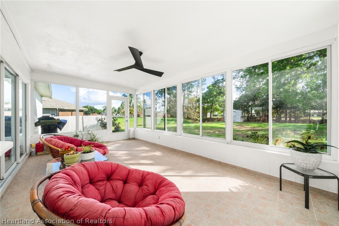 3102 Divot Road Sebring, FL 33872 - Photo 19 of 24 Nice tiled, Florida room with pass-thru window to kitchen