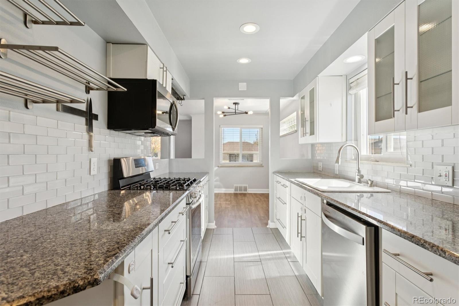81 South Ingalls Street Lakewood, CO 80226 - Photo 13 of 29 a kitchen with a sink stove top oven and microwave