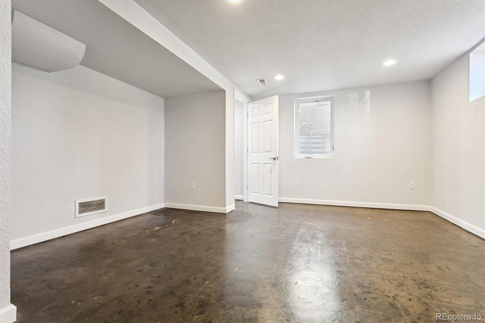 81 South Ingalls Street Lakewood, CO 80226 - Photo 20 of 29 an empty room with wooden floor and windows with curtains