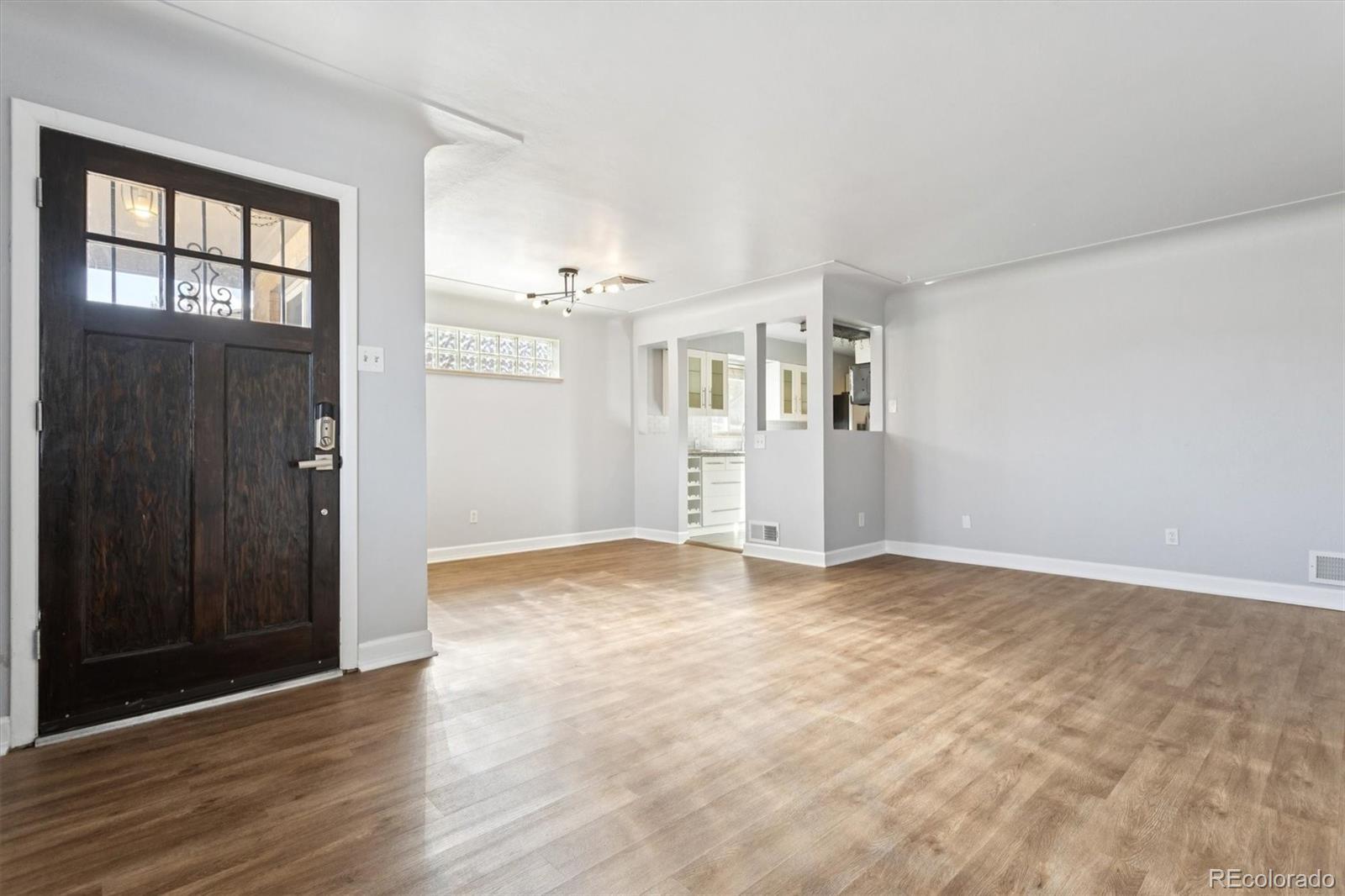 81 South Ingalls Street Lakewood, CO 80226 - Photo 7 of 29 a view of empty room with wooden floor and windows