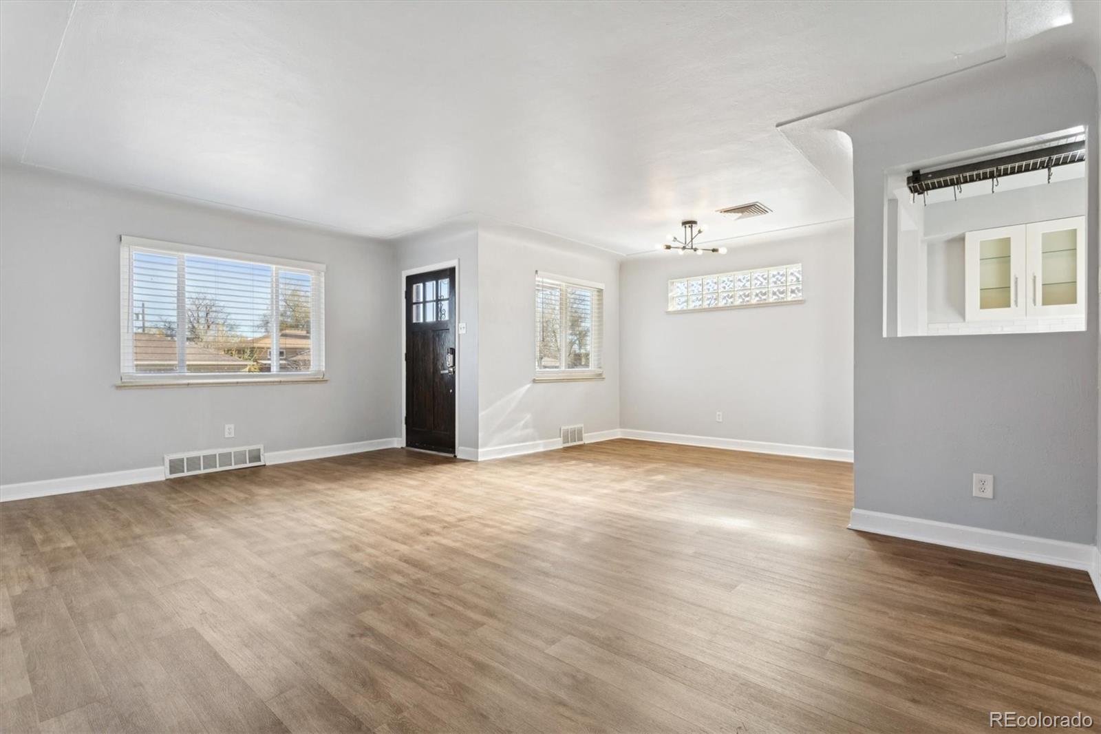 81 South Ingalls Street Lakewood, CO 80226 - Photo 8 of 29 a view of an empty room with wooden floor and a window
