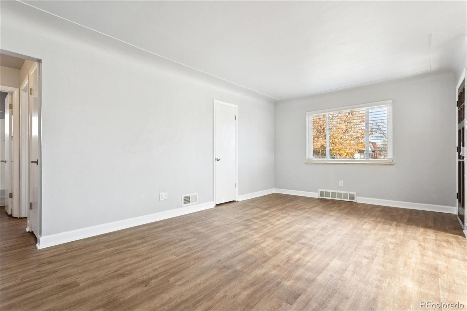 81 South Ingalls Street Lakewood, CO 80226 - Photo 9 of 29 an empty room with wooden floor and windows