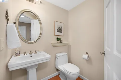 a spacious bedroom with a bed and glass walk in closet