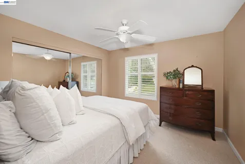 a view of a patio with a dining table and chairs under an umbrella