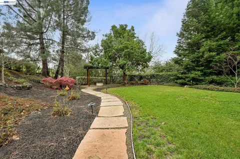 a outdoor space with patio the couches and a dining table with the garden view