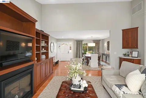 a living room with furniture a rug and a window