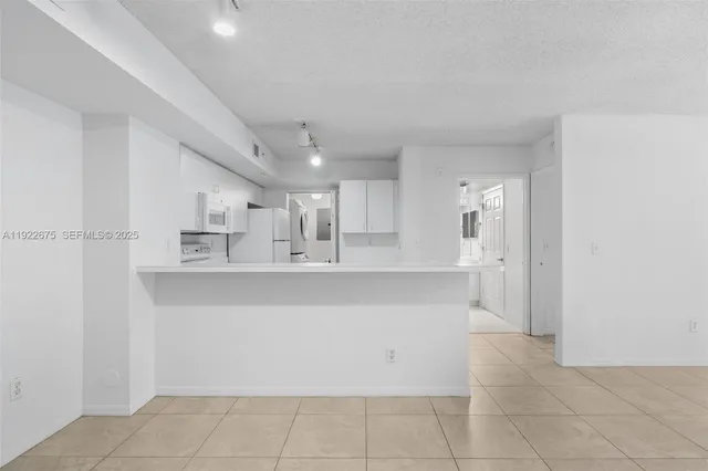 a view of a kitchen with marble kitchen and kitchen space