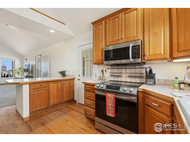 a kitchen with stainless steel appliances granite countertop a stove a sink dishwasher and a microwave