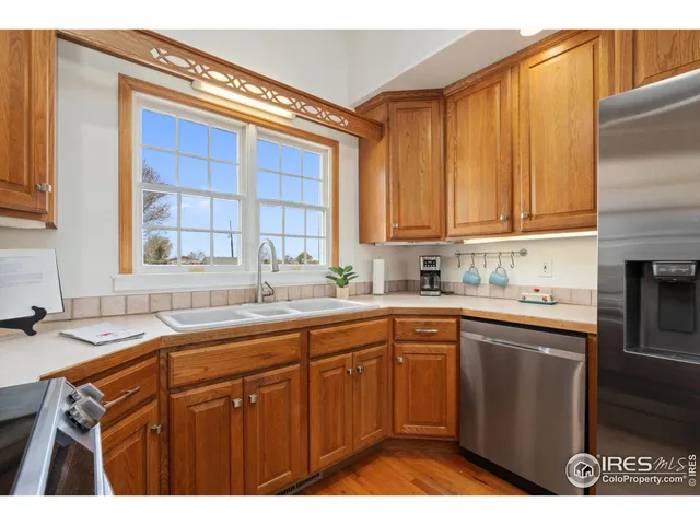 a kitchen with a sink cabinets and window