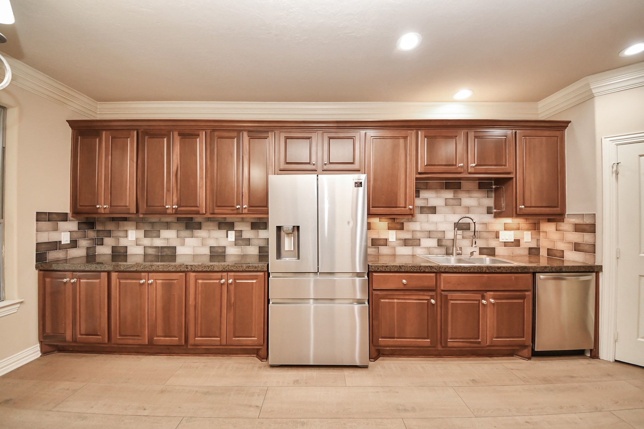 14454 Summerleaf Lane Houston, TX 77077 - Photo 22 of 50 a kitchen with granite countertop a refrigerator and a stove top oven