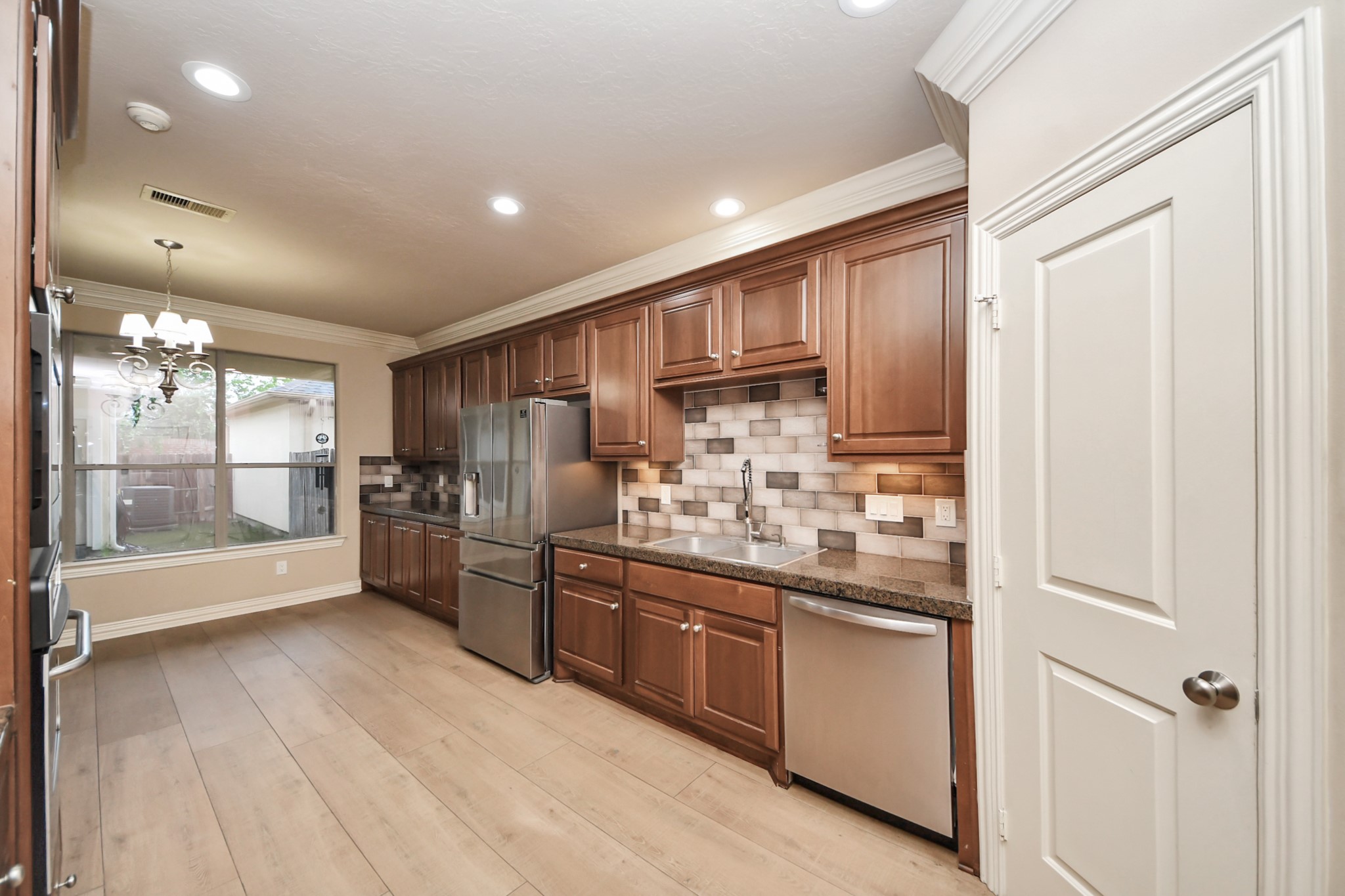 14454 Summerleaf Lane Houston, TX 77077 - Photo 24 of 50 a kitchen with stainless steel appliances kitchen island granite countertop a refrigerator and a stove top oven