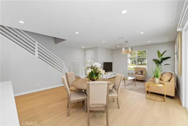 a view of a dining room with furniture and a potted plant