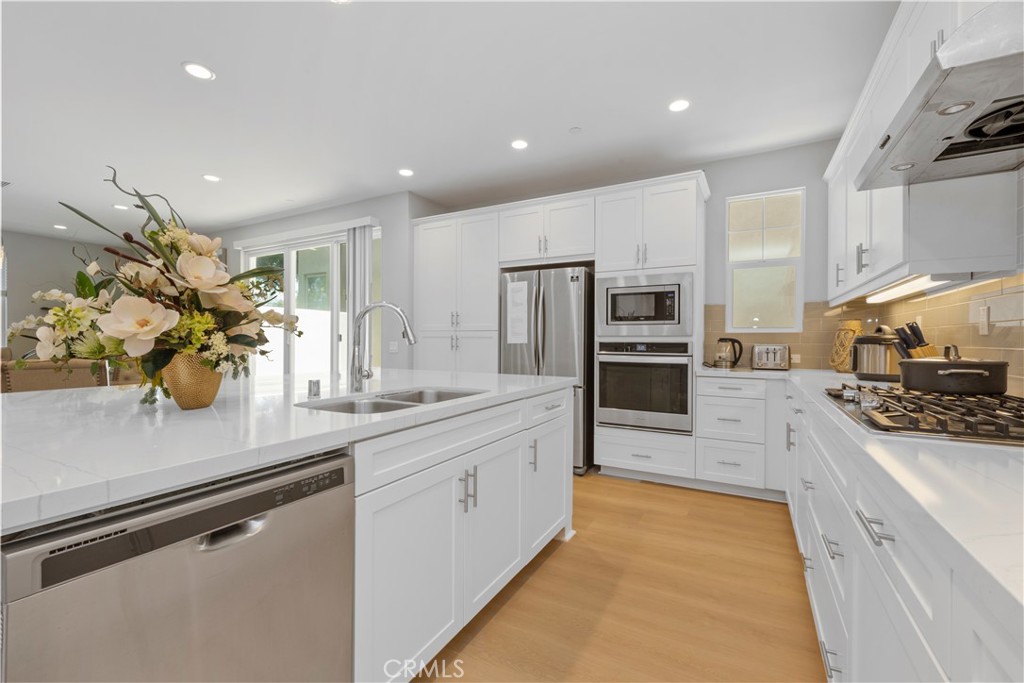 136 Modjeska Irvine, CA 92618 - Photo 13 of 39 a kitchen with stainless steel appliances kitchen island granite countertop a sink and cabinets