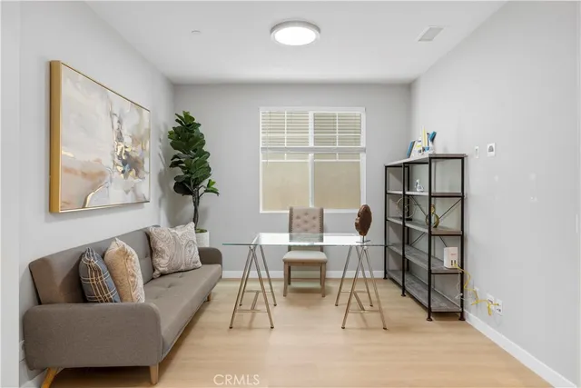 a living room with furniture a rug and a window