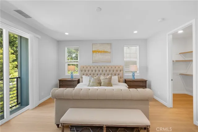 a bedroom with furniture and wooden floor