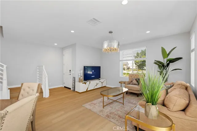 a living room with furniture potted plant and a window