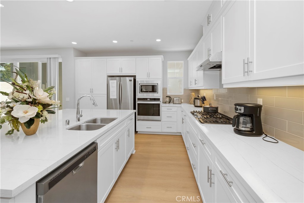 136 Modjeska Irvine, CA 92618 - Photo 8 of 39 a large kitchen with stainless steel appliances lots of counter space and a sink