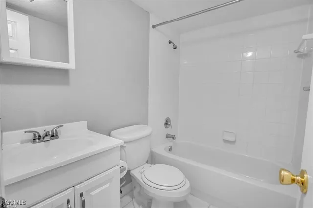 a white toilet sitting next to a bath tub