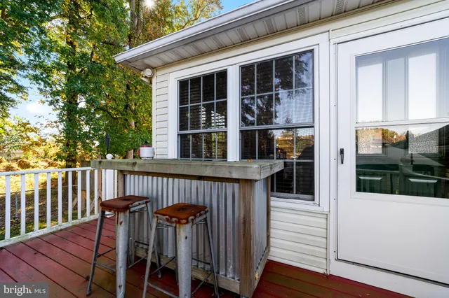 a view of a deck with chairs and wooden floor
