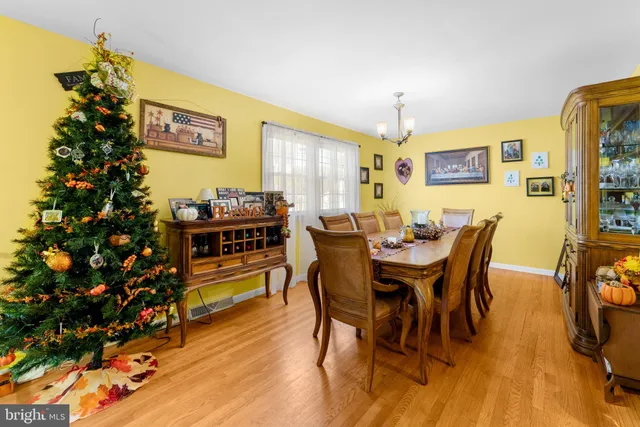 a view of a dining room with furniture and chandelier