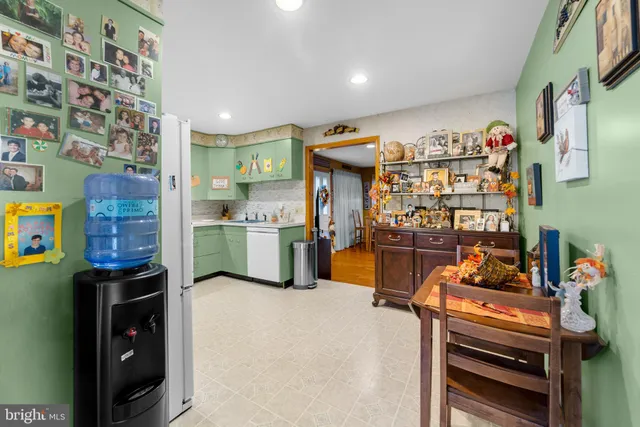 a kitchen with stainless steel appliances wooden floor and a refrigerator