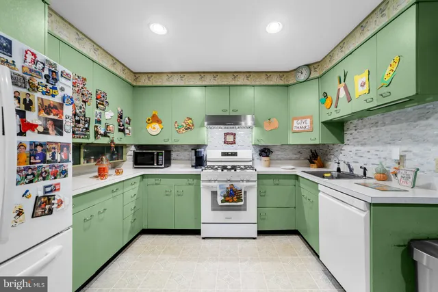 a kitchen with stainless steel appliances granite countertop a sink and cabinets