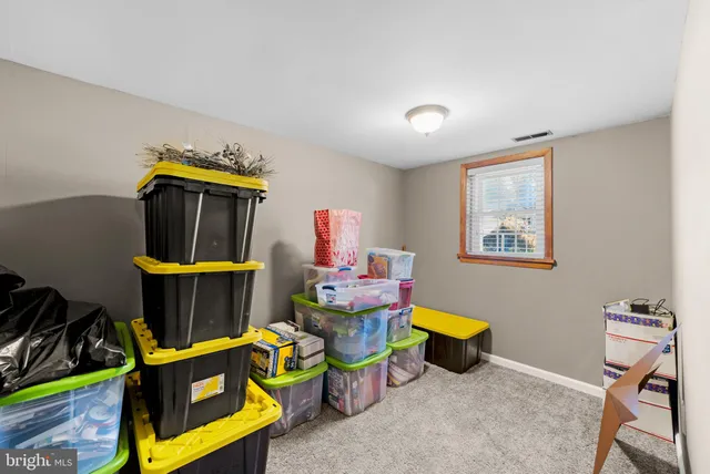 a living room with furniture a air conditioner and a window