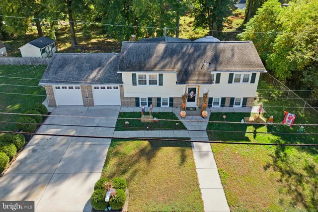 a view of house with garden space and sitting area