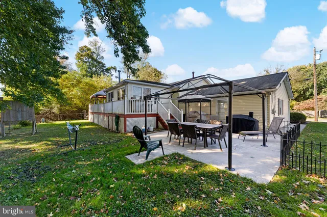 a view of a house with a yard porch and sitting area