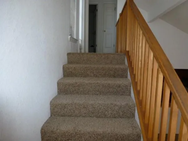a view of staircase with rug