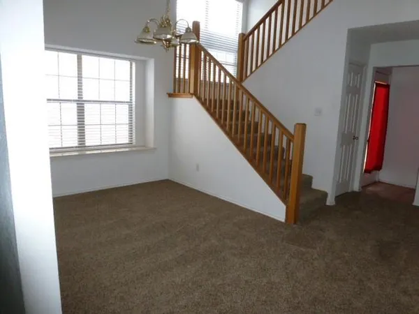 a view of an empty room with stairs